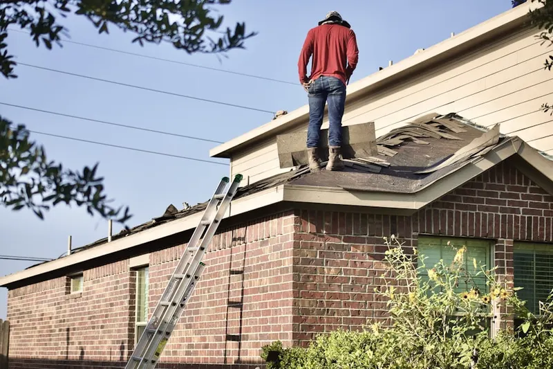 Professional roofer working on a residential roof in Cains Corners